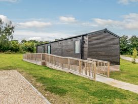 A cabin with a ramp and green grass at Alford WF in Louth