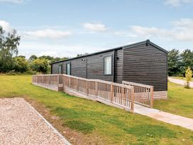 A cabin with decking on the side at Alford WF in Louth