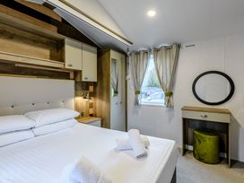 A bedroom with a bed and nightstand at Alford WF in Louth