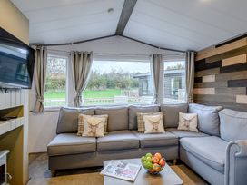 A snug with a sofa, television, and coffee table at Alford WF in Louth