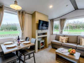 A living room with a dining area and television at Alford WF in Louth