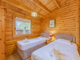 A bedroom with two beds and a window at Cedar Lodge in Louth