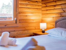 A bedroom with a bed and a nightstand at Cedar Lodge Louth
