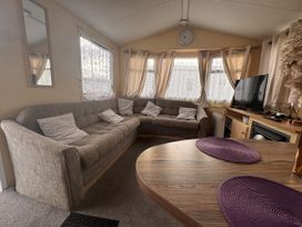 A living room with a sofa and television at 29 Laburnham Court in Fleetwood