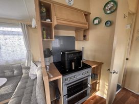 A kitchen with an oven and a coffee machine at 29 Laburnham Court in Fleetwood