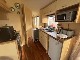 A kitchen with appliances and a sink at 29 Laburnham Court in Fleetwood