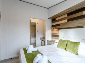 A bedroom with a bed and bedside table at Elsham Lodge in Louth