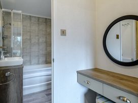 A bathroom featuring a sink, shower and bath at Elsham Lodge in Louth