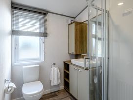 A bathroom with a shower, sink, and toilet at Elsham Lodge in Louth