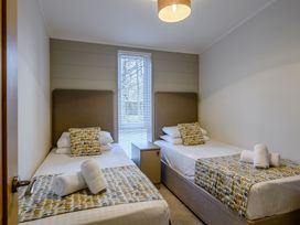 A bedroom with twin beds and a nightstand at Stamford Spa in Louth