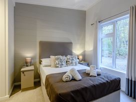 A bedroom with a bed and nightstand at Stamford Spa in Louth
