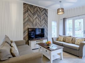 A living room with a television and a coffee table at Stamford Spa in Louth
