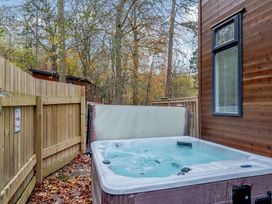 An outdoor space featuring a hot tub with a wooden fence at Stamford Spa in Louth
