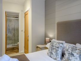 A bedroom with a bed and attached shower at Stamford Spa (Pet) in Louth