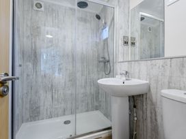 A bathroom with a shower and sink at Stamford Spa (Pet) in Louth