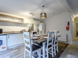 A kitchen with dining table and chairs at Stamford Spa (Pet) in Louth
