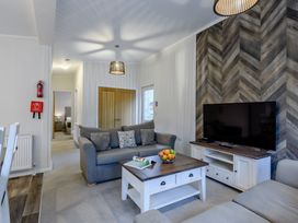 A living room with a sofa and television at Stamford Spa (Pet) Louth