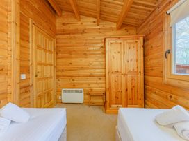 A bedroom with two beds and a wardrobe at Cedar Lodge (Pet) Louth