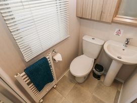 A bathroom with a toilet and sink at Woodland View