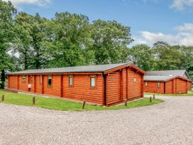 Log cabins surrounded by trees at Hazel Lodge in Louth
