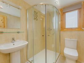 A bathroom with a shower, toilet, and sink at Hazel Lodge in Louth