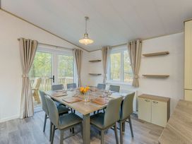 A dining room with a table and chairs at Brayford Lodge in Louth