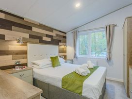 A bedroom with a bed and window at Brayford Lodge in Louth
