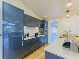 A kitchen with modern appliances and a fruit bowl at Retreat Lodge 4 in Louth
