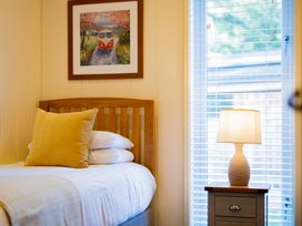 A bedroom with a bed and nightstand at Retreat Lodge 4 in Louth