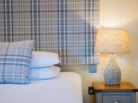 A bedroom with pillows and a lamp on a nightstand at Retreat Lodge 4 in Louth