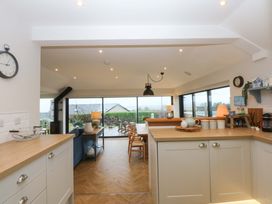 A kitchen with a view of the garden at Bryn Mor Cottage Mynytho near Llanbedrog