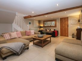 A living room with a sofa and coffee table at Bryn Mor Cottage Mynytho near Llanbedrog