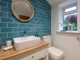 A bathroom with a sink and toilet at Bryn Mor Cottage in Mynytho near Llanbedrog