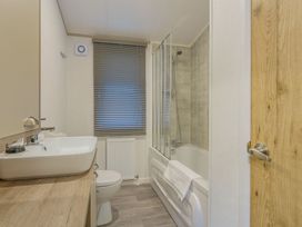 A bathroom with a shower and bathtub at Brayford Lodge Spa Louth