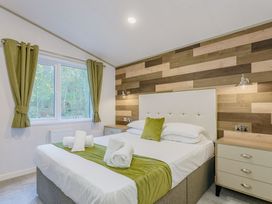 A bedroom with a bed and window at Brayford Lodge Spa in Louth