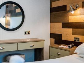 A bedroom with a vanity table and mirror at Brayford Lodge Spa in Louth