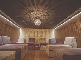 A spa room with lounge chairs and a chandelier at Brayford Lodge Spa in Louth