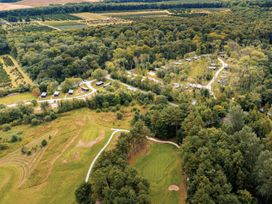 An aerial view of cabins and a golf course in a forest area at Brayford Lodge Spa in Louth