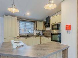 A kitchen with appliances and dishes at Brayford Lodge Spa (Pet) Louth