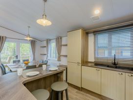 A dining area with a table and chairs at Brayford Lodge Spa (Pet) Louth