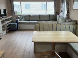 A living room with a sofa and coffee table at New Caravan