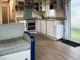 A kitchen area with a sofa and appliances at New Caravan