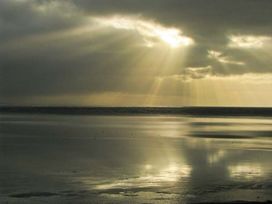 A view of the sea with light breaking through clouds at Priory View Ulverston