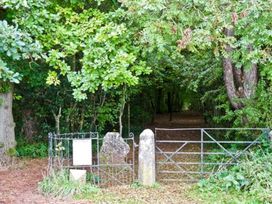 A gate leading into a wooded area at Priory View in Ulverston