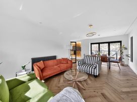 A living room with sofas and a dining table at Heddfan in Carmarthen
