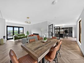 A living room with a dining table and chairs at Heddfan in Carmarthen