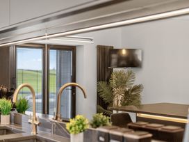 A kitchen with a sink and a television at Heddfan in Carmarthen