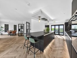 A kitchen with an island and dining area at Heddfan in Carmarthen