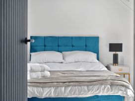 A bedroom with a bed and bedside table at Heddfan in Carmarthen