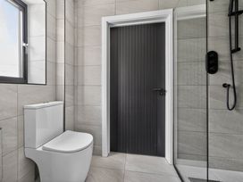 A bathroom with a toilet and a shower at Heddfan in Carmarthen